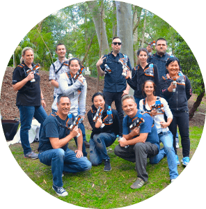 Group of Corporate Executives posing at an Outdoor Laser Tag Team Building Event